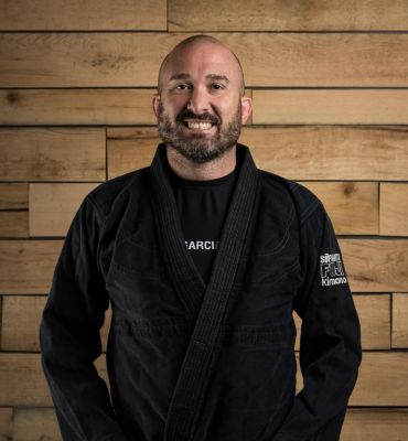 David Brogan — 4th degree black belt in Judo, 2nd degree black belt in Brazilian Jiu Jitsu, 1st degree black belt in Tae Kwon Do, Head Instructor in Brazilian Jiu-Jitsu