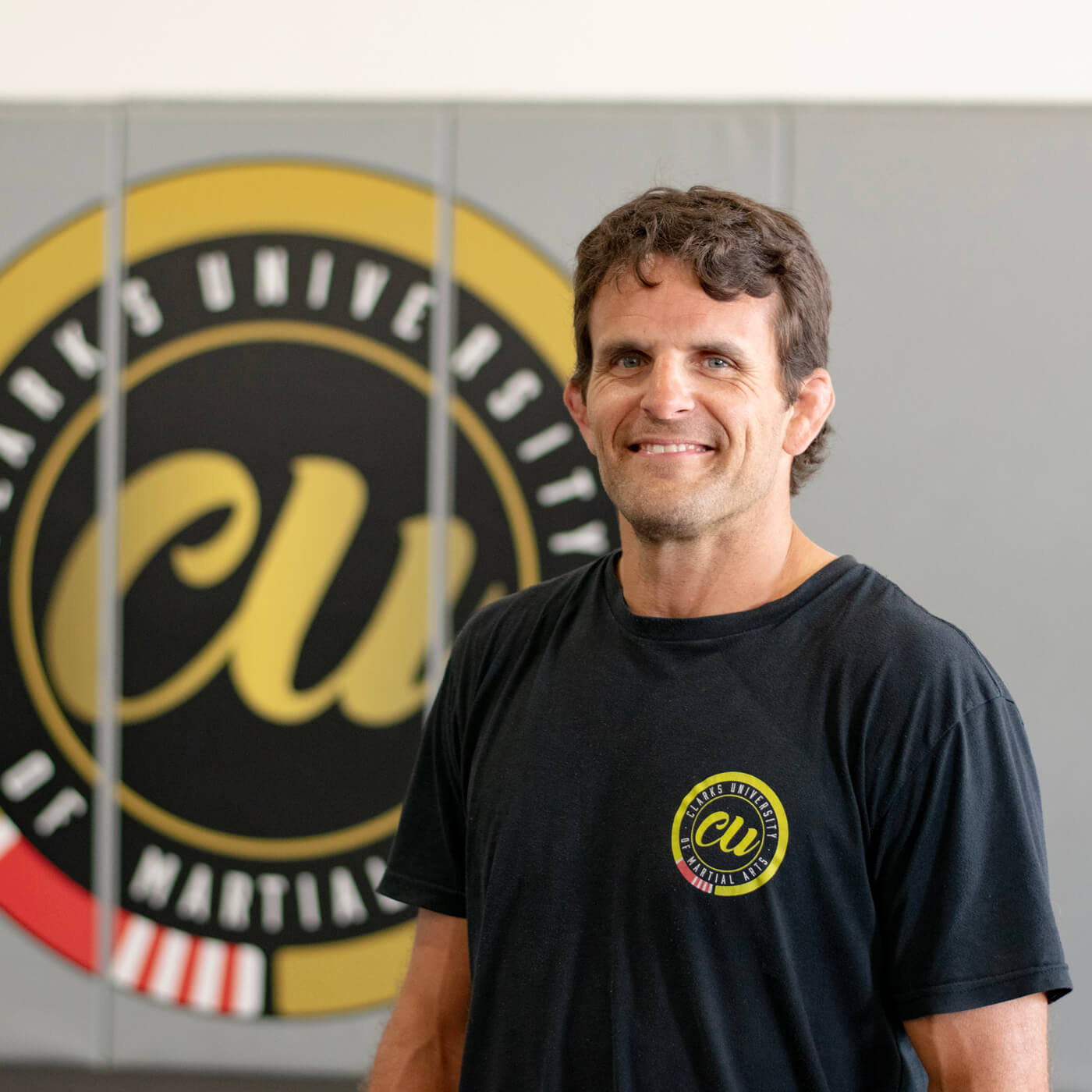 Ryan Clark — 3rd degree Black Belt (site lists both 3rd and 5th degree in different pages), Coach in Brazilian Jiu-Jitsu